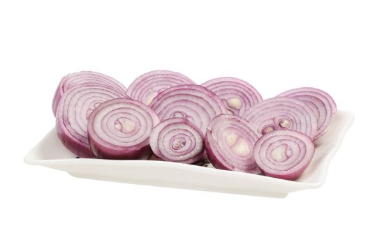 Dish with chopped red onion circles. Isolated on white.
