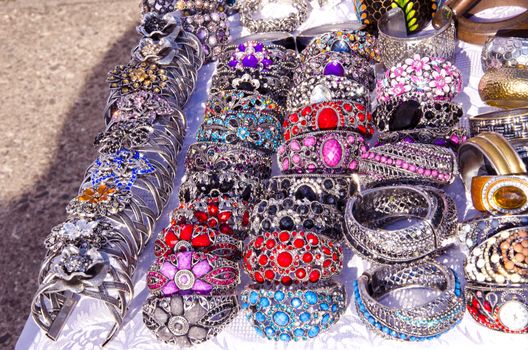 Decorative handmade jewelry bracelets and head ring sold in outdoor fair market.