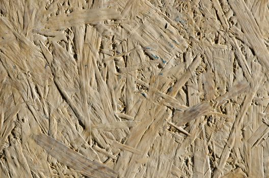 background of chipboard wooden chip plank sheet wall closeup details.