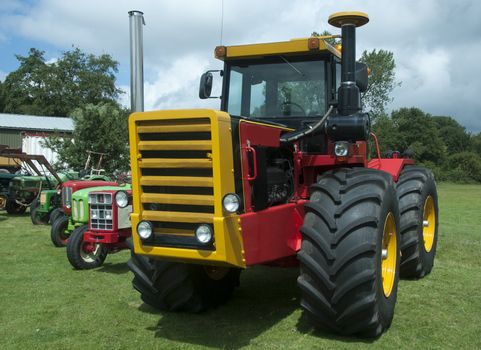 big wheel machinery in green field