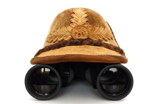 concept with old hunting hat and binoculars on white background