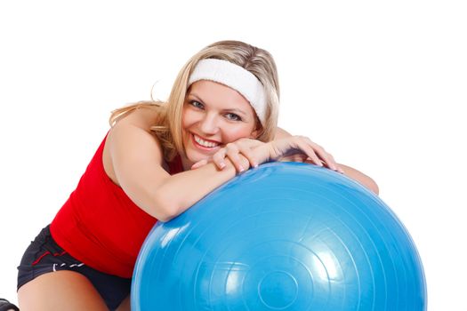 Beautiful, sexy athlete with fitball on white background.