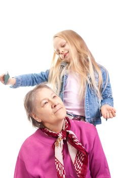 Granddaughter make grandmother hairstyle on white background