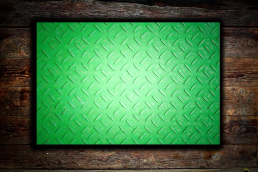 Metal plate on wooden background