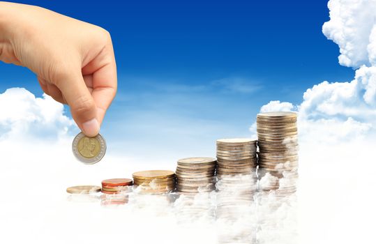 Invest. Conceptual image.  and lot of coins over blue sky background