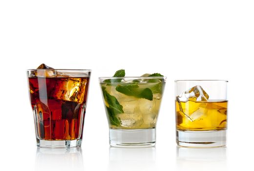 Three alcoholic cocktails on white background