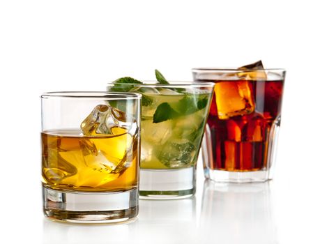 Three alcoholic cocktails on white background