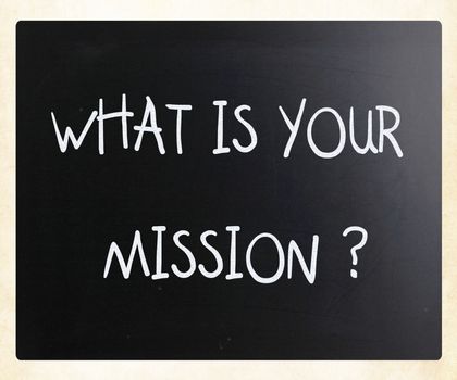 "What is your mission " handwritten with white chalk on a blackboard