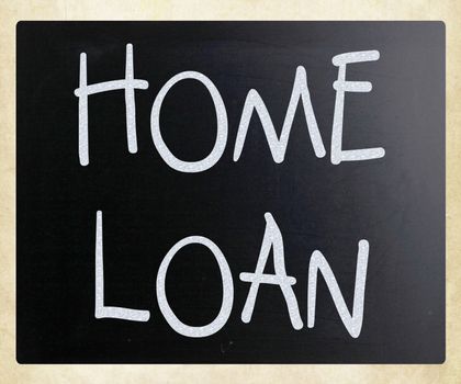 "Home loan" handwritten with white chalk on a blackboard