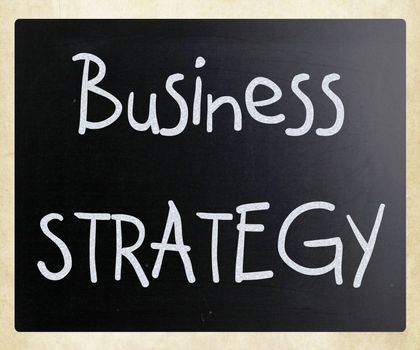 "Business strategy" handwritten with white chalk on a blackboard