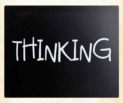"Thinking" handwritten with white chalk on a blackboard