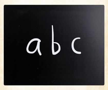 "abc" handwritten with white chalk on a blackboard