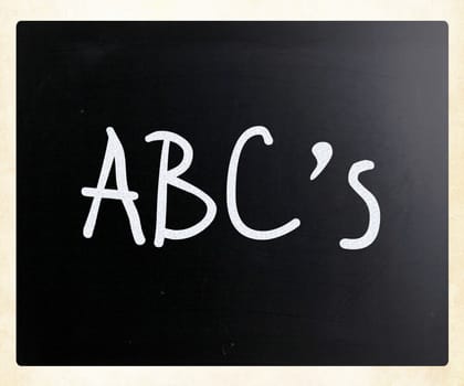 "ABC's" handwritten with white chalk on a blackboard