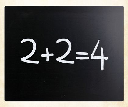 "2+2=4" handwritten with white chalk on a blackboard