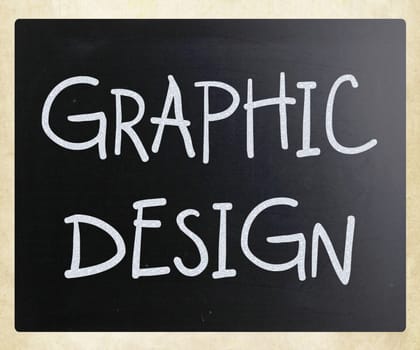 "Graphic design" handwritten with white chalk on a blackboard