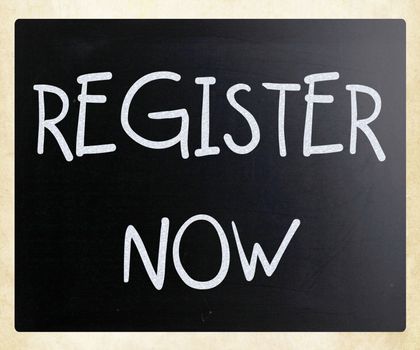 "Register now" handwritten with white chalk on a blackboard