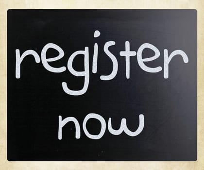 "Register now" handwritten with white chalk on a blackboard