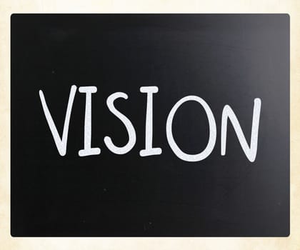 "Vision" handwritten with white chalk on a blackboard