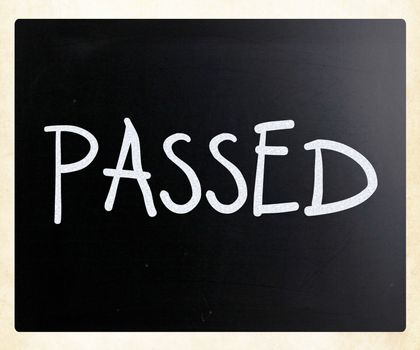"Passed" handwritten with white chalk on a blackboard