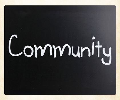 "Community" handwritten with white chalk on a blackboard