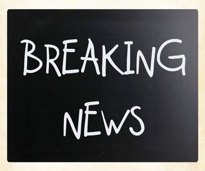 "Breaking news" handwritten with white chalk on a blackboard
