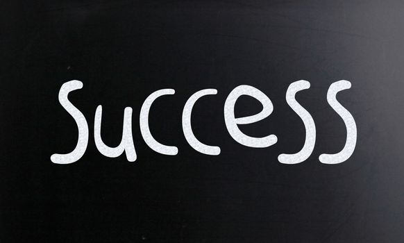 The word "Success" handwritten with white chalk on a blackboard