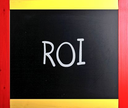 The word "ROI" handwritten with white chalk on a blackboard