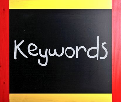 The word "Keywords" handwritten with white chalk on a blackboard