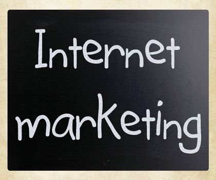 "Internet marketing" handwritten with white chalk on a blackboard