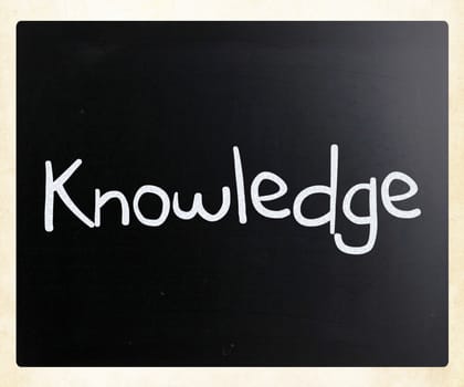 "Knowledge" handwritten with white chalk on a blackboard