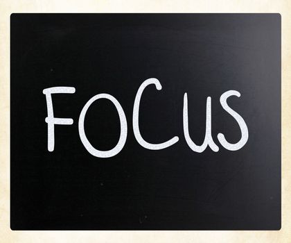 The word "Focus" handwritten with white chalk on a blackboard