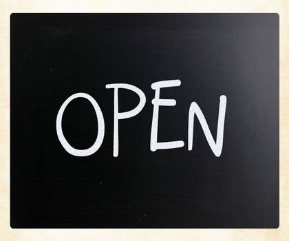 The word "Open" handwritten with white chalk on a blackboard