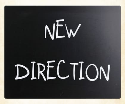"New direction" handwritten with white chalk on a blackboard