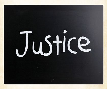 The word "Justice" handwritten with white chalk on a blackboard