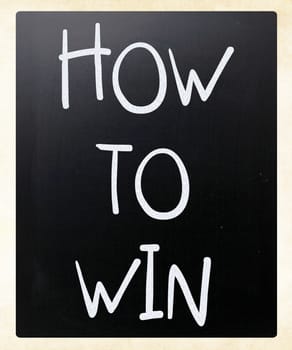 "How to win" handwritten with white chalk on a blackboard