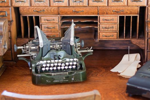 antique type writer on vintage roll top desk