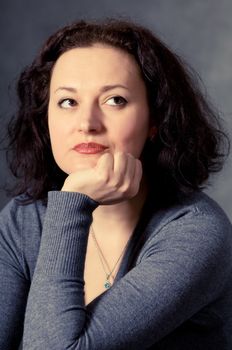 portrait of a pensive woman on a dark background