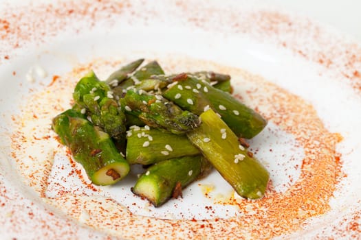 Fried Asparagus on white plate closeup