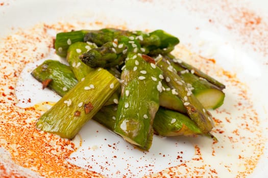 Fried Asparagus on white plate closeup