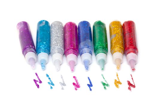 Set Colorful sparkle glue pens on white background