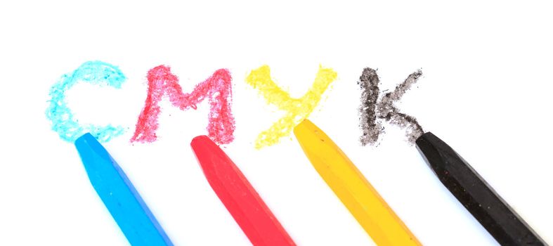 Sign of the CMYK from pastel crayons on white