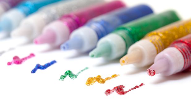 Set Colorful sparkle glue pens on white background