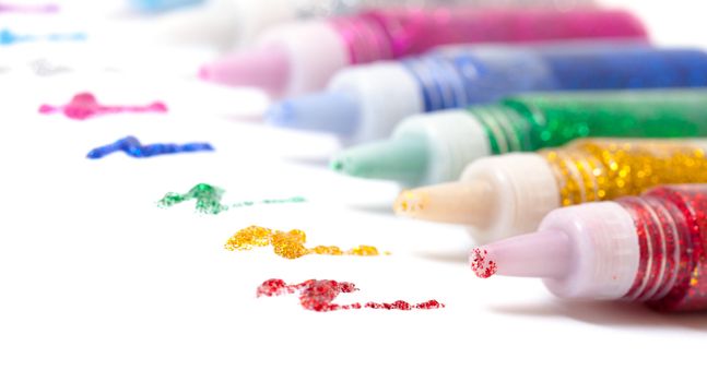 Set Colorful sparkle glue pens on white background