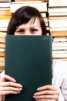Student girl hiding behind big book
