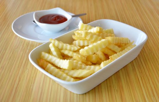  french fries on  white plate served with tomato sauce