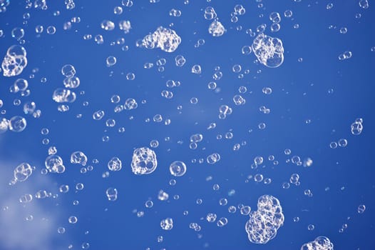 Soap bubbles before blue sky