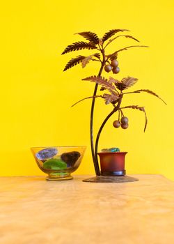 decorative metal tree with yellow wall