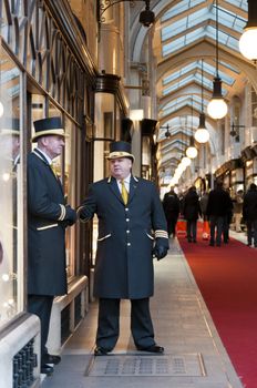 LONDON, UK - JANUARY 13: Traditional doormen in front of Burlington Arcade. January 13, 2012 in London. Plans to replace the mall's floor were thrown out after a legal battle, but renewal works have started despite opposition by shop owners.