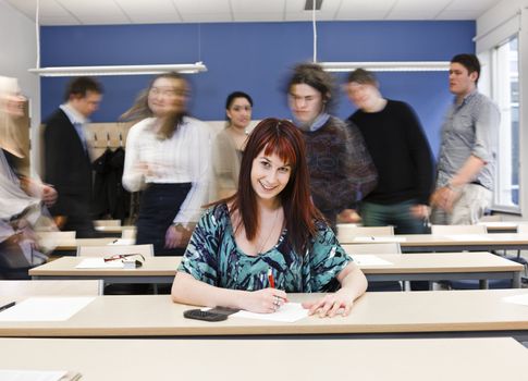 Working girl among moving pupils at the end of the Class