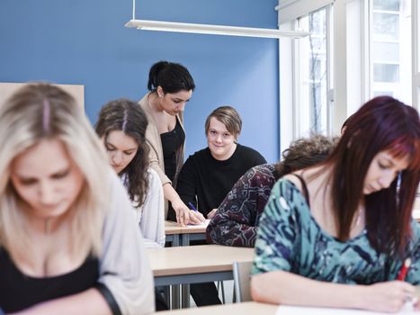 Teacher and young Adult students in the classroom